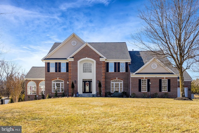 view of front of house with a front lawn and brick siding