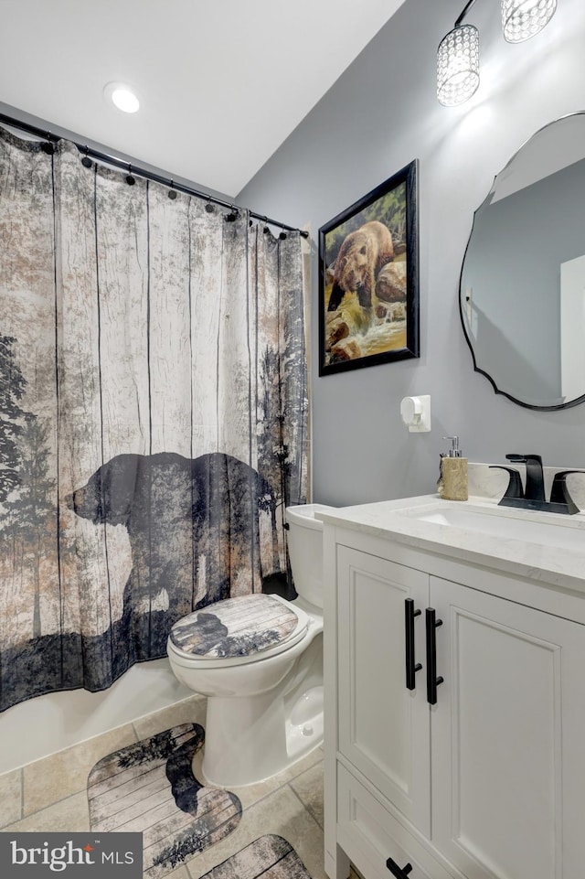 bathroom with curtained shower, vanity, and toilet