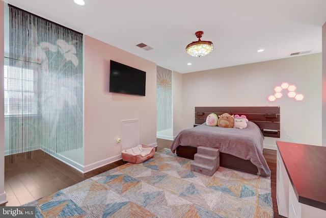 bedroom with wood finished floors, visible vents, and recessed lighting