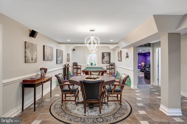 dining area with a notable chandelier, recessed lighting, stone tile flooring, and baseboards