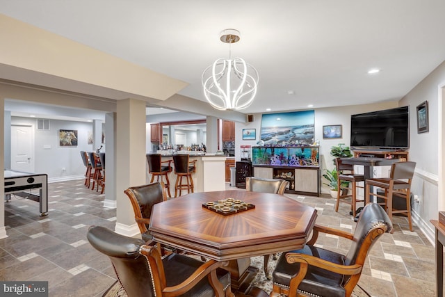 dining area with recessed lighting, visible vents, baseboards, stone tile flooring, and an inviting chandelier