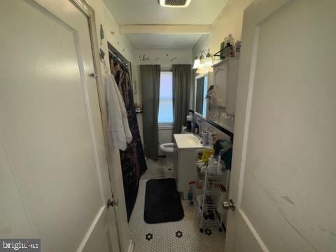 1628 Gleneagle Rd, Baltimore, MD 21239 - bathroom featuring vanity, tile patterned floors, and toilet