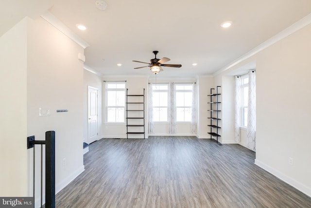 spare room featuring dark hardwood / wood-style flooring, crown molding, and ceiling fan