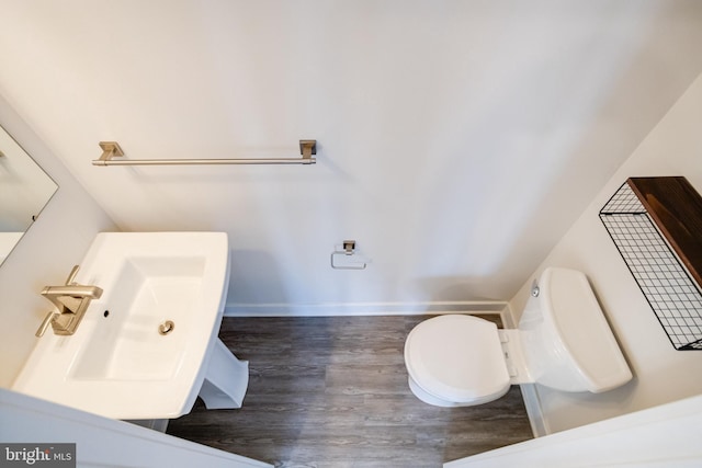 bathroom featuring hardwood / wood-style flooring, sink, and toilet