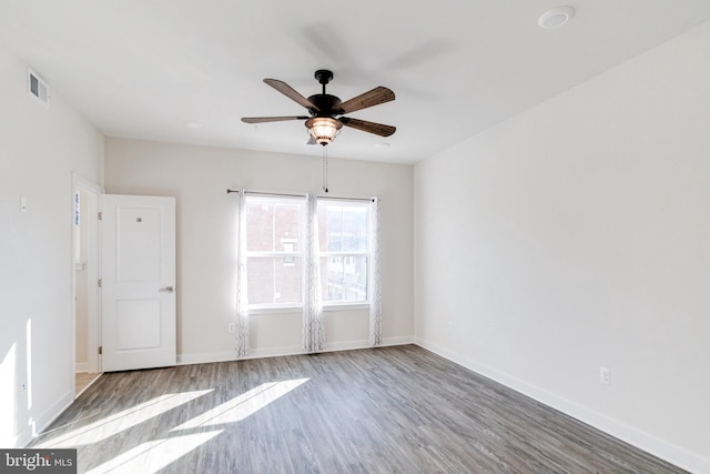 empty room featuring hardwood / wood-style flooring and ceiling fan