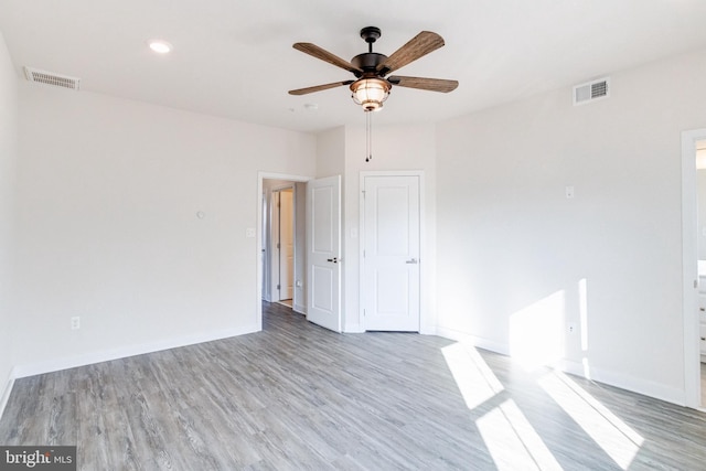 empty room featuring ceiling fan and light wood-type flooring