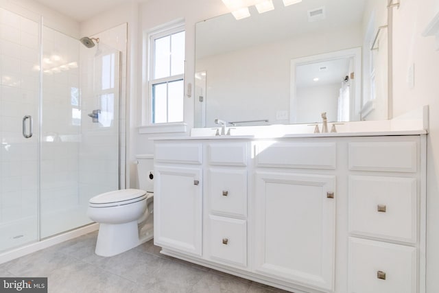 bathroom featuring walk in shower, tile patterned floors, vanity, and toilet