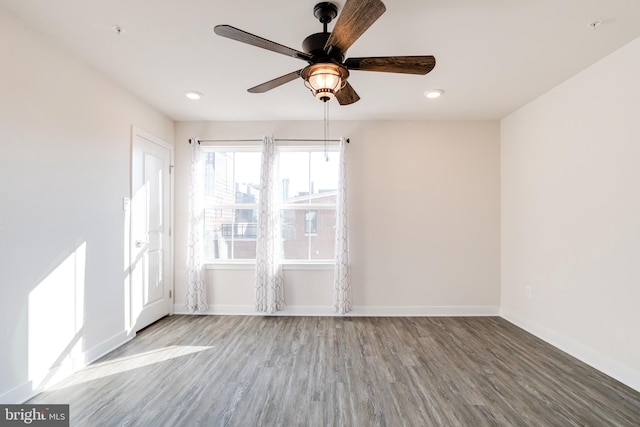 spare room with hardwood / wood-style flooring and ceiling fan