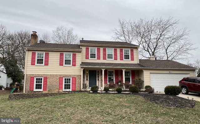 view of front facade with a garage, a front yard, and a porch