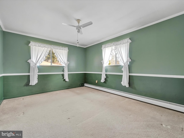 spare room with a baseboard radiator, ornamental molding, and a wealth of natural light