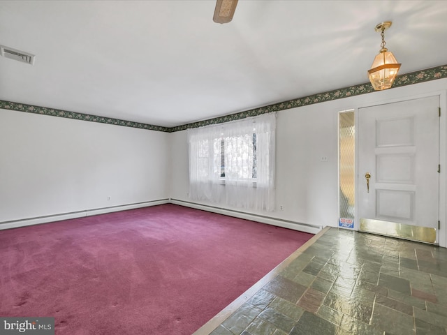 spare room with baseboard heating and dark colored carpet