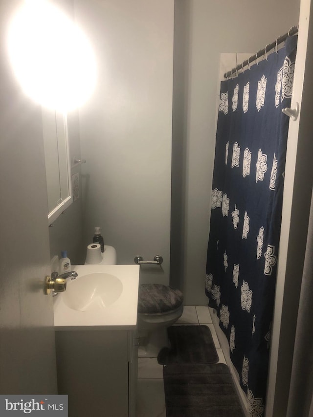 bathroom featuring vanity and toilet