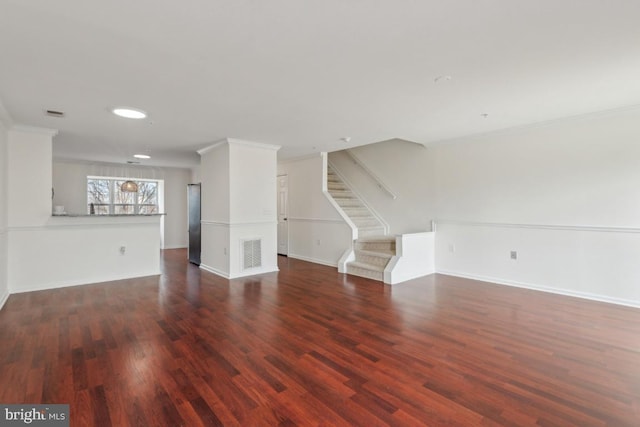 unfurnished living room featuring ornamental molding and dark hardwood / wood-style flooring