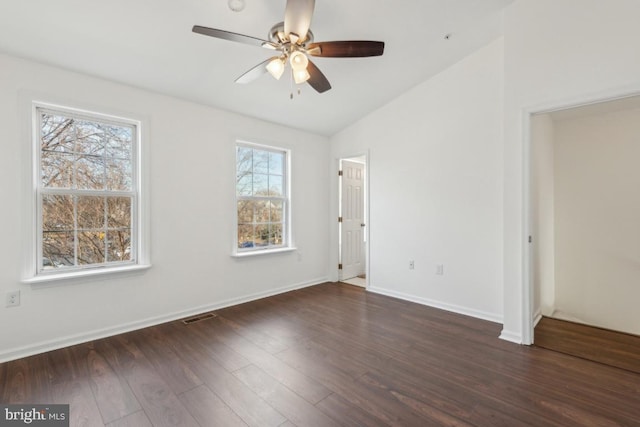 spare room with vaulted ceiling, dark hardwood / wood-style floors, and ceiling fan