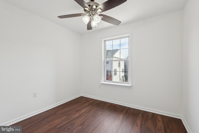 empty room featuring ceiling fan and dark hardwood / wood-style flooring