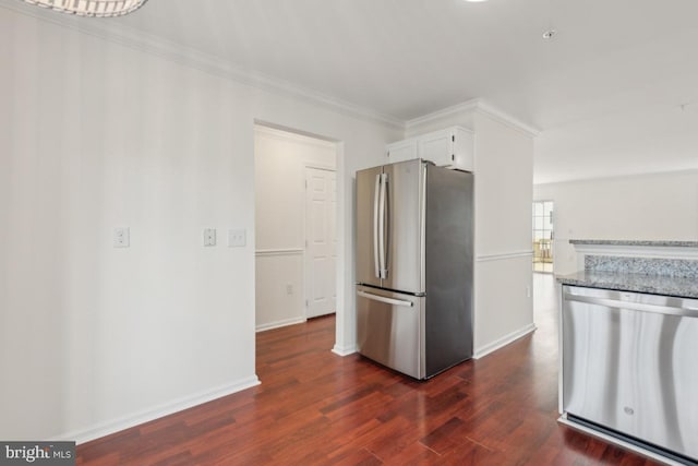 kitchen with crown molding, appliances with stainless steel finishes, dark hardwood / wood-style flooring, light stone countertops, and white cabinets