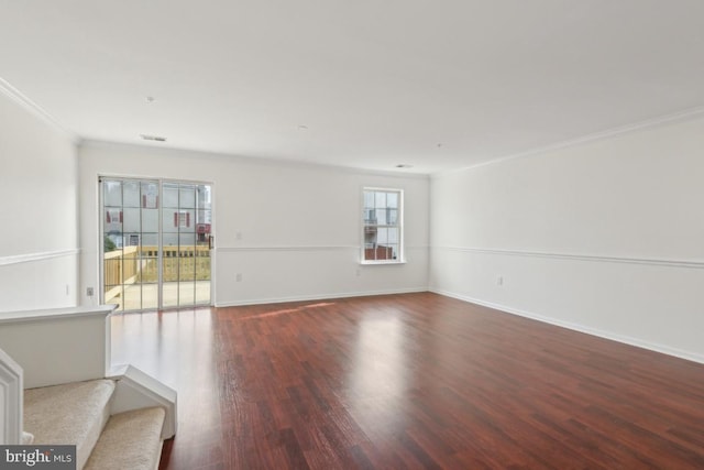 spare room featuring hardwood / wood-style flooring and ornamental molding