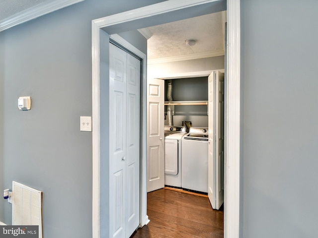 hallway with crown molding, dark hardwood / wood-style floors, and washing machine and dryer