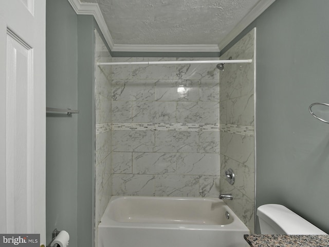 bathroom with a textured ceiling, ornamental molding, toilet, and tiled shower / bath