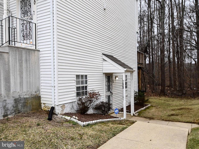 view of side of home with a lawn