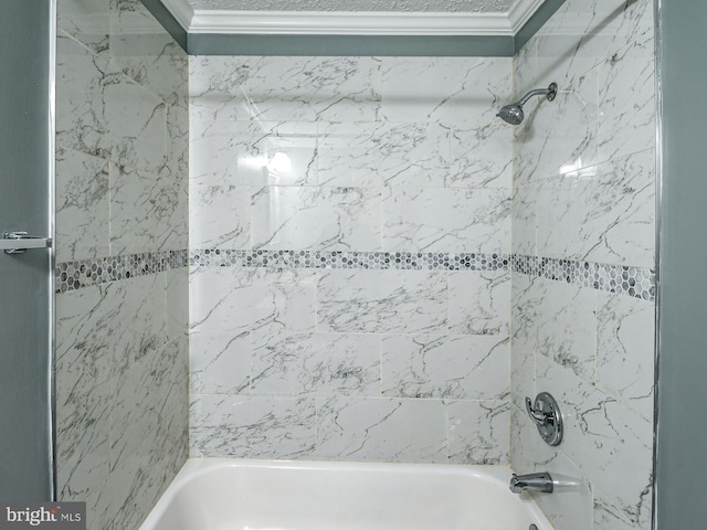 bathroom featuring crown molding and tiled shower / bath combo