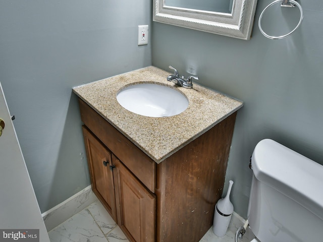 bathroom featuring vanity and toilet