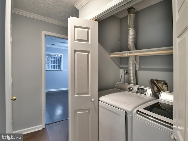 clothes washing area with separate washer and dryer, ornamental molding, dark hardwood / wood-style floors, and a textured ceiling