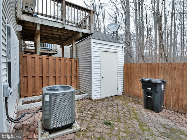 view of patio / terrace with cooling unit and a storage unit