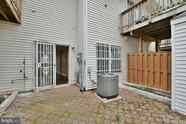 view of patio / terrace with cooling unit and a balcony