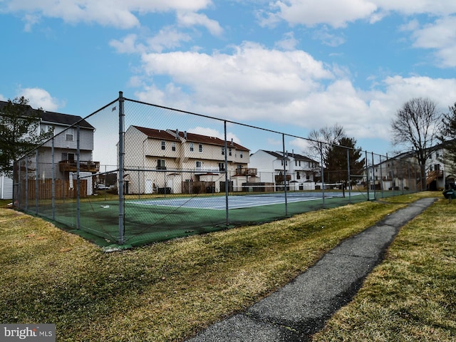 view of sport court featuring a yard