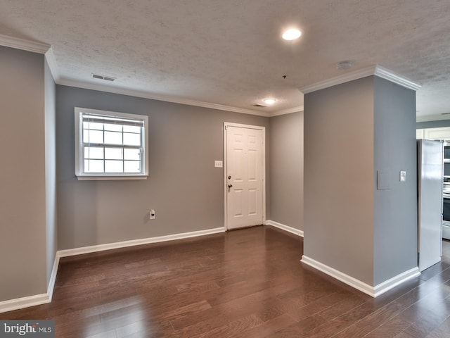 spare room with crown molding, dark hardwood / wood-style floors, and a textured ceiling