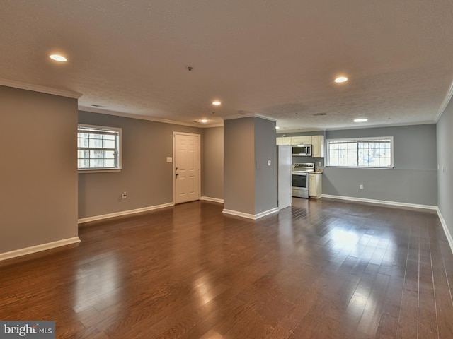 unfurnished living room with dark hardwood / wood-style flooring, plenty of natural light, and ornamental molding