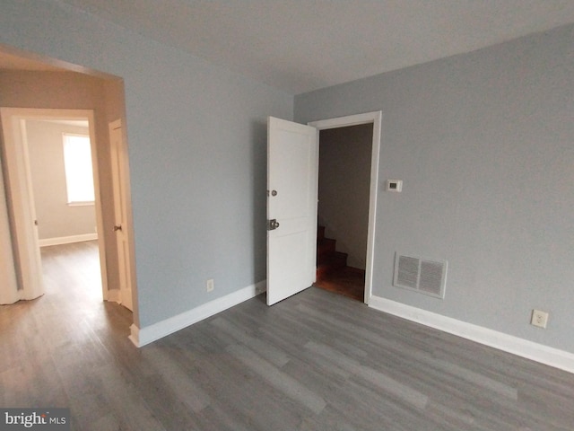 unfurnished room featuring dark hardwood / wood-style floors