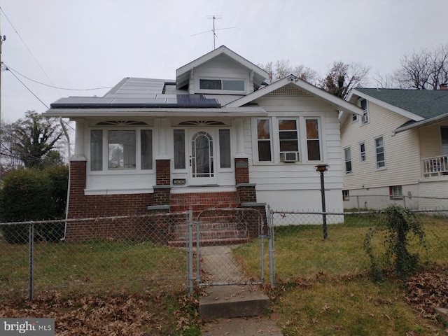 bungalow-style house with cooling unit, a front lawn, and solar panels