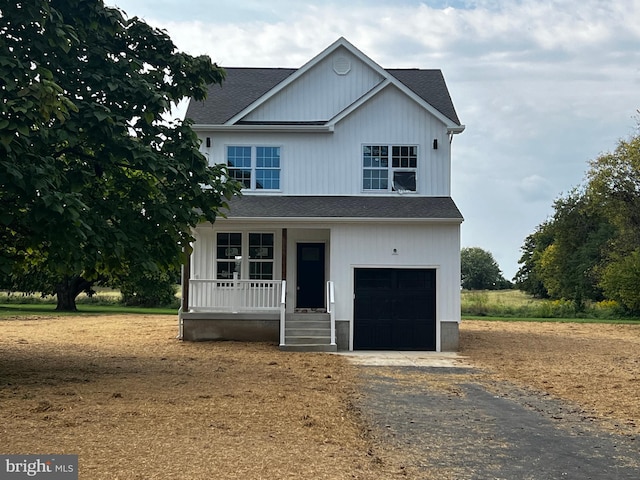 view of front of property featuring a garage and a porch