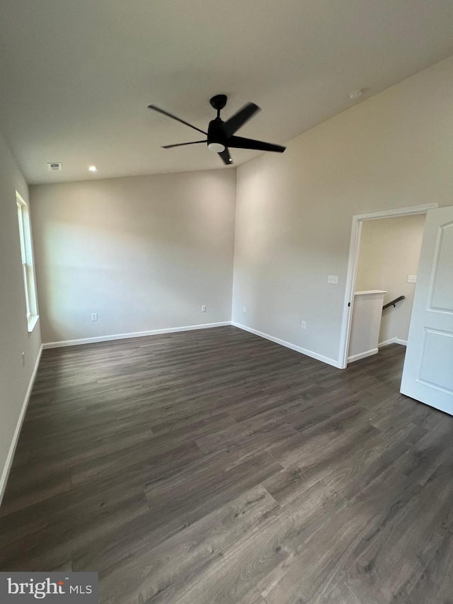 spare room with dark hardwood / wood-style flooring and ceiling fan