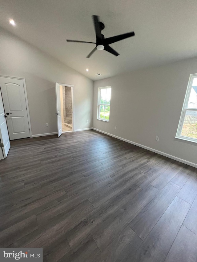 unfurnished room featuring ceiling fan, dark hardwood / wood-style floors, and vaulted ceiling