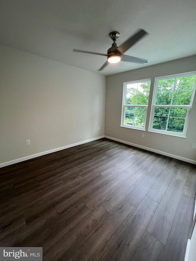 spare room with ceiling fan and dark hardwood / wood-style flooring