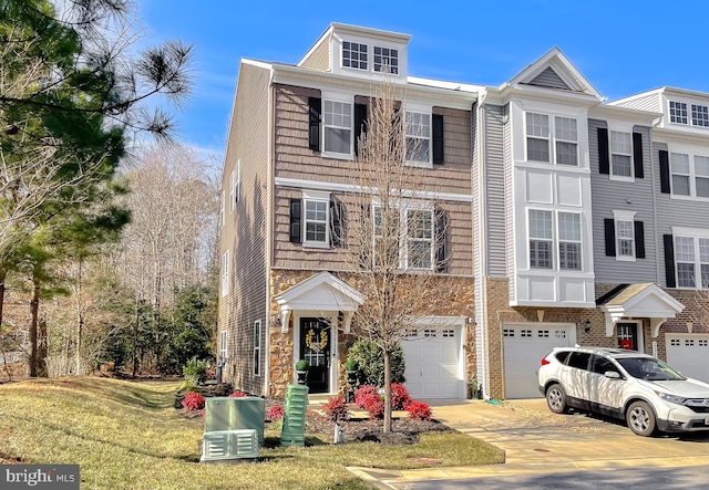 view of property with a garage and a front yard