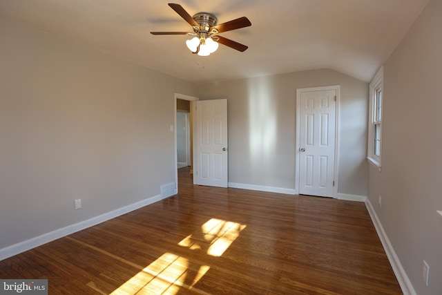 unfurnished room featuring vaulted ceiling, dark hardwood / wood-style floors, and ceiling fan