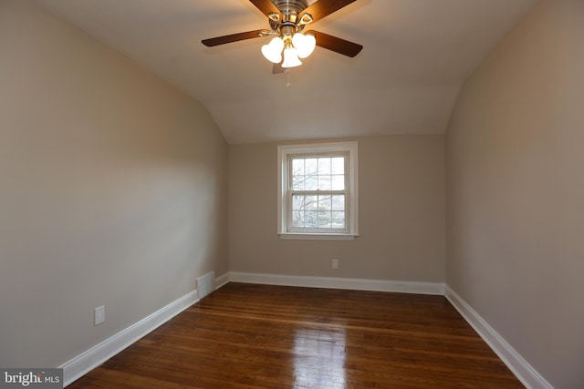 spare room with ceiling fan, lofted ceiling, and dark hardwood / wood-style flooring