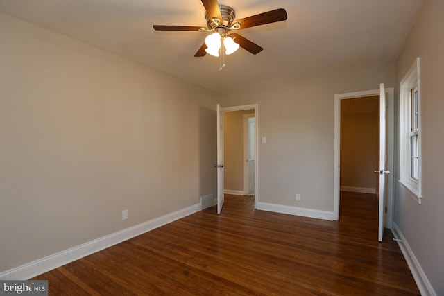 unfurnished bedroom featuring dark wood-type flooring and ceiling fan