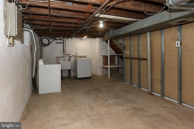 basement featuring washing machine and dryer and sink