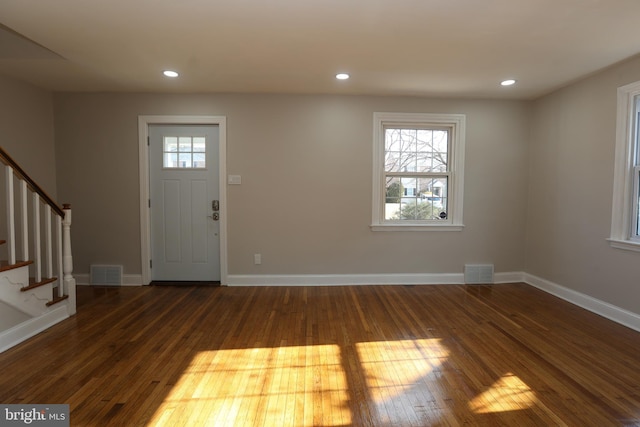 entrance foyer with dark wood-type flooring and plenty of natural light