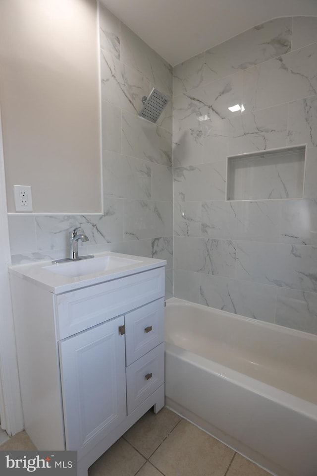 bathroom featuring vanity, tiled shower / bath combo, and tile walls