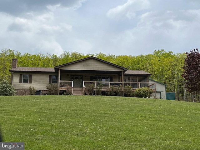 view of front of house with a front lawn, a porch, central AC unit, and a chimney