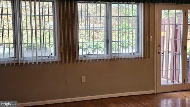 entryway with wood finished floors and baseboards