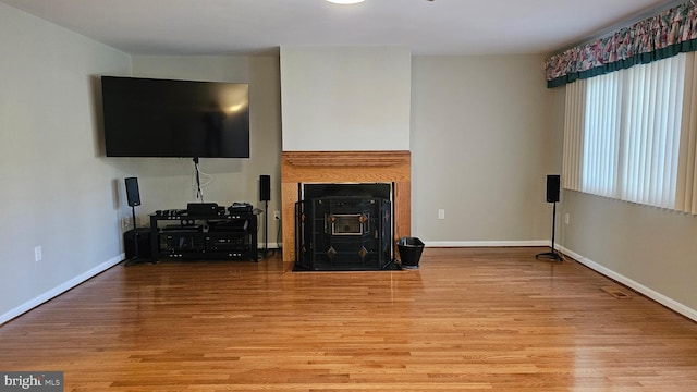 living area featuring baseboards and wood finished floors