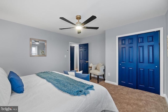 bedroom with carpet, a closet, ceiling fan, and baseboards