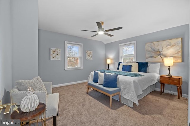 bedroom with light carpet, baseboards, and multiple windows